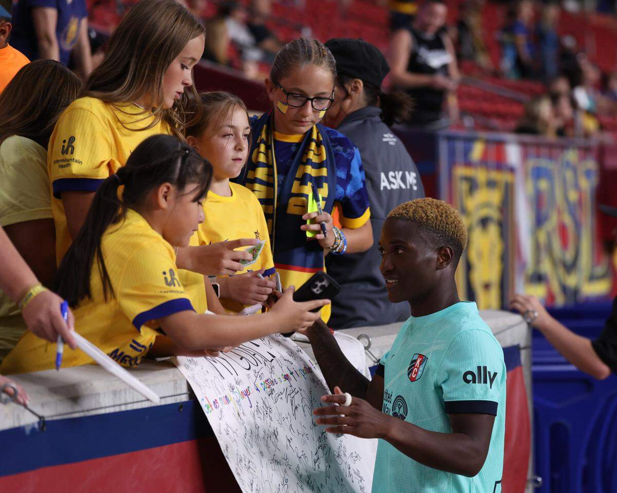 Kansas City Current forward Temwa Chawinga (right) interacts with fans after the game against the Utah Royals FC at America First Field on Aug. 8, 2025.