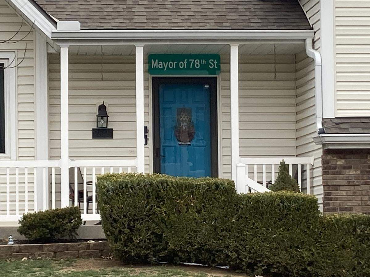 In tribute to Christopher Wells, a new sign hangs above the family's front door: “Mayor of 78th Street.”