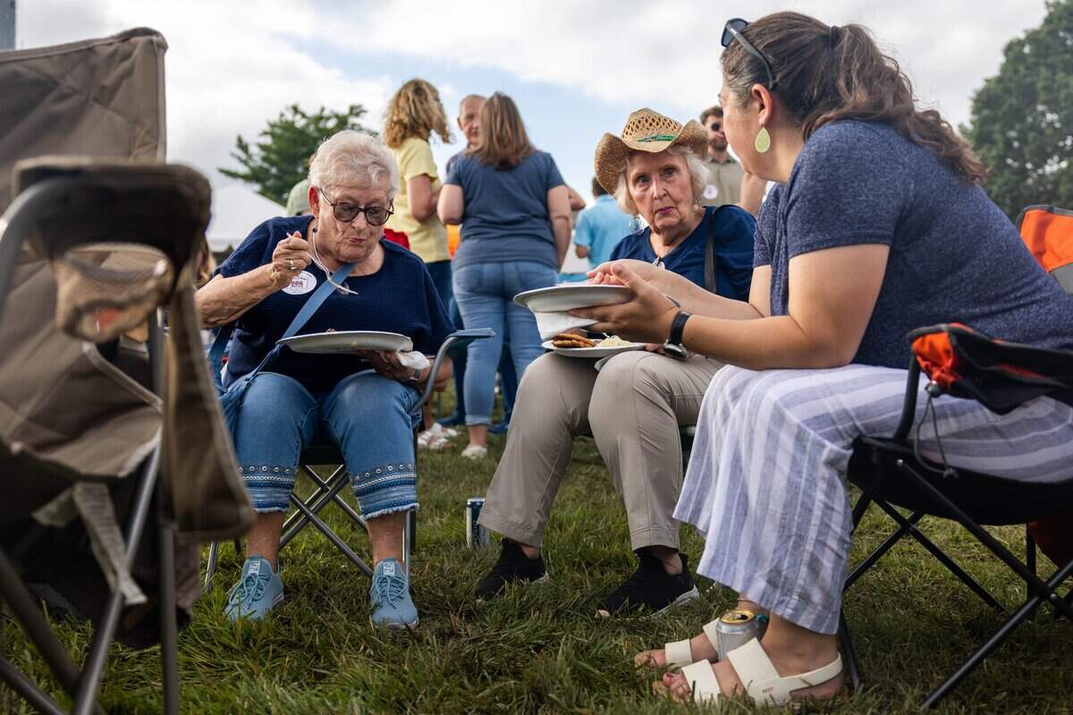 LouAnne Bruce, left, Sheryl Shnell, and Tara Bird sit and chat as they eat barbecue at The Great Lenexa BBQ Battle on Friday, June 26, 2026.
