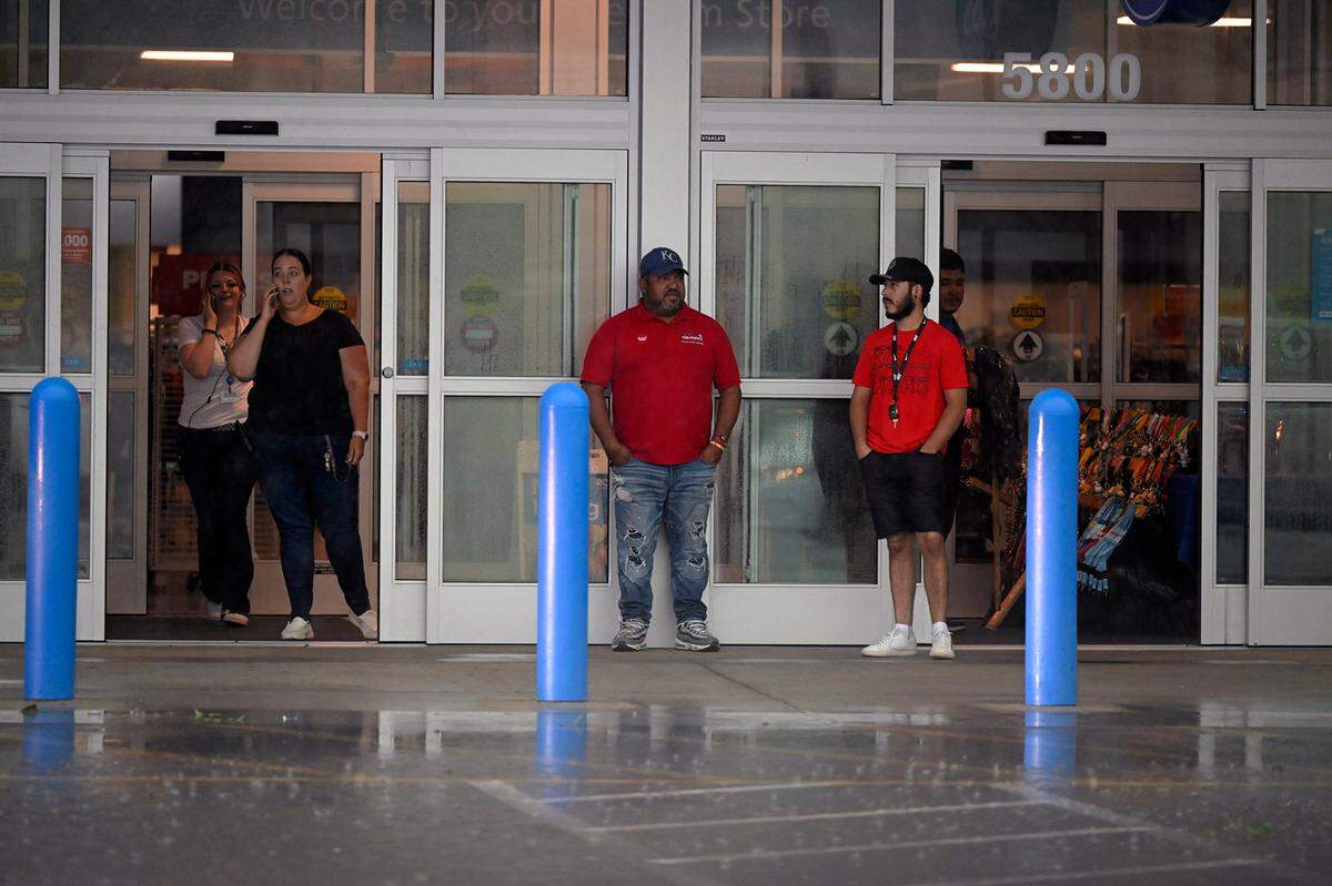 Customers stood in the doorway after a storm bringing heavy rain took the power at the Ross store in Merriam on Friday, July 14, 2023.