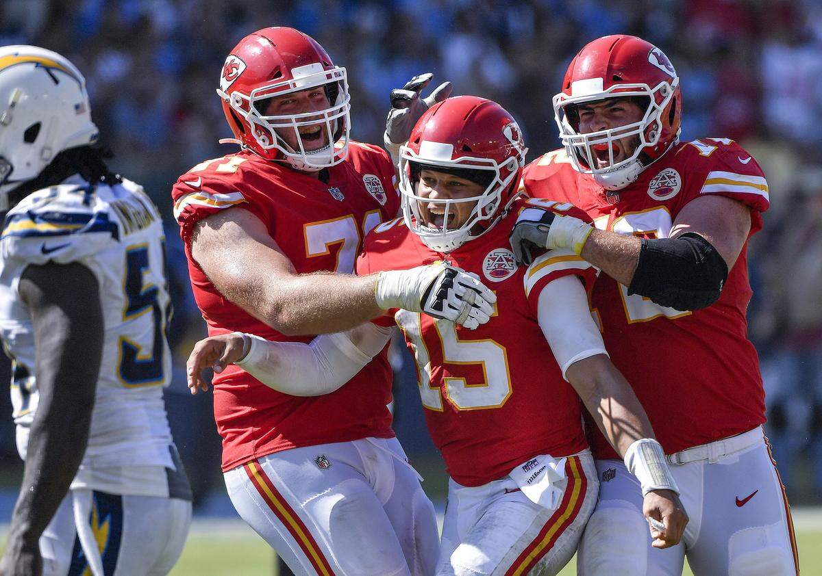 Kansas City Chiefs quarterback Patrick Mahomes celebrated with tackles Mitchell Schwartz (left) and Eric Fisher after throwing a touchdown pass to running back Anthony Sherman in the third quarter against the Chargers. It was Mahomes’ third touchdown pass of the 2018 season.