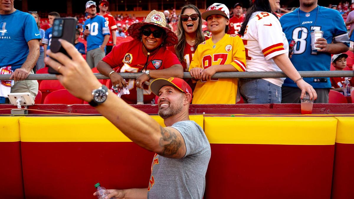 Former Kansas City Chiefs quarterback Chad Henne takes a selfie with fans before an NFL football game against the Detroit Lions on Thursday, Sept. 7, 2023, in Kansas City.