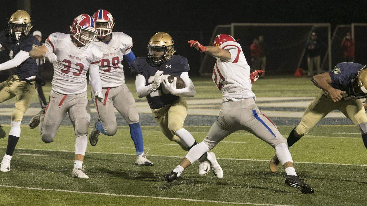 Tank Young (center) rushed for 287 yards and three touchdowns for Saint Thomas Aquinas in its home win over Bishop Miege on Friday night.