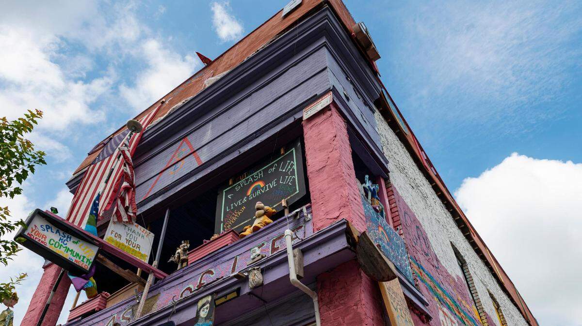 The iconic pink building on Troost Avenue in Kansas City will be removed from dangerous buildings list.
