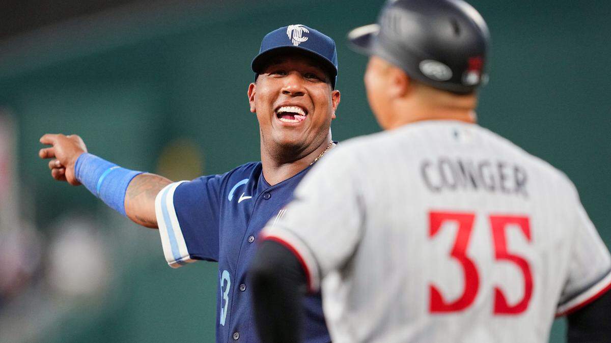 Jul 28, 2023; Kansas City, Missouri, USA; Kansas City Royals first baseman Salvador Perez (13) talks with Minnesota Twins first base/catching coach Hank Conger (35) during the sixth inning at Kauffman Stadium. Mandatory Credit: Jay Biggerstaff-USA TODAY Sports