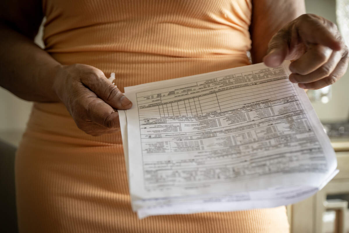 Diahna Carroll holds a copy of the KCPD’s crash report, which has no mention of a police pursuit in the Jan. 2, 2024, crash that claimed the life of her husband, Alphonso “Duke” Carroll, 60. Carroll spoke at her home on Thursday, Aug. 14, 2025, in Lee’s Summit.