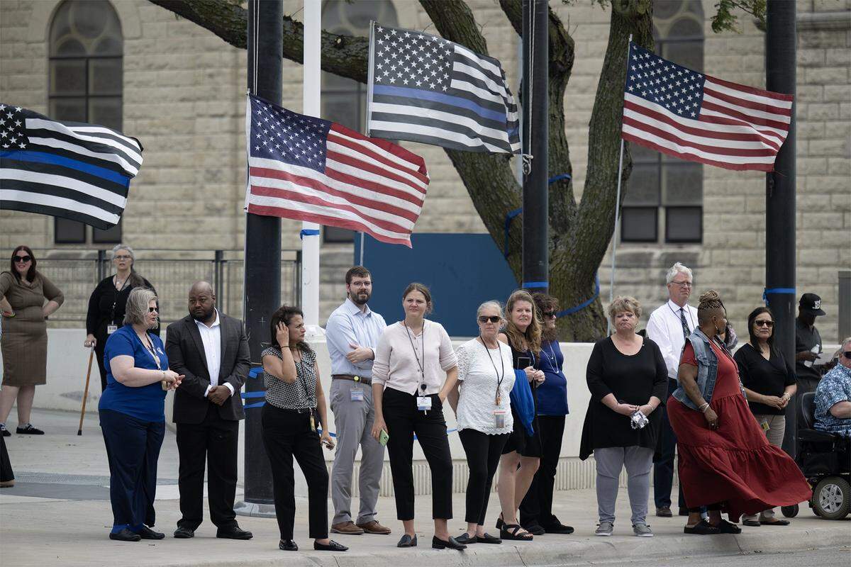 People gathered along the street to pay their respects to Kansas City, Kansas Police Officer Hunter Simoncic as his funeral procession traveled through downtown Kansas City, Kansas, on Wednesday, Sept. 3, 2025.