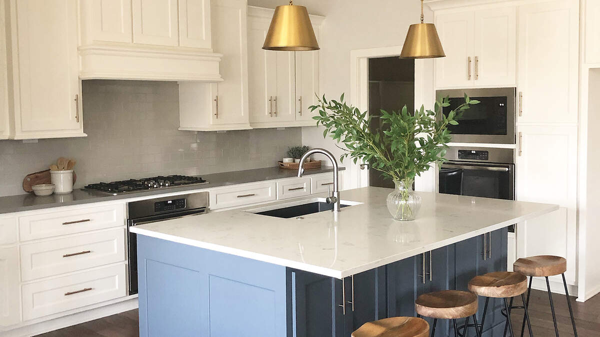Custom cabinetry and hardwood floors are among the luxurious kitchen finishes offered in Covington Creek’s Alexander reverse story and a half plan.