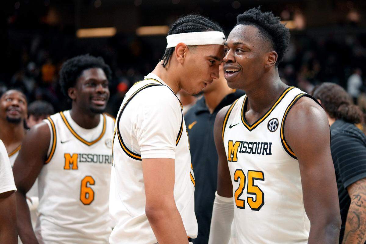 Forward Trent Pierce #11 of the Missouri Tigers and forward Mark Mitchell #25 of the Missouri Tigers celebrate an overtime win over the Oklahoma Sooners in the first half at Mizzou Arena on January 24, 2026 in Columbia.