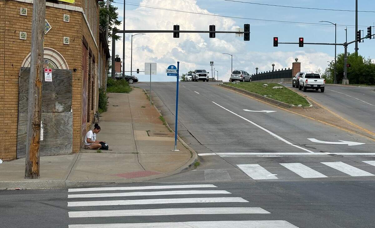 A woman waits for a bus at the RideKC stop on the corner of 39th Street and Woodland Avenue on Thursday, June 4, 2026.