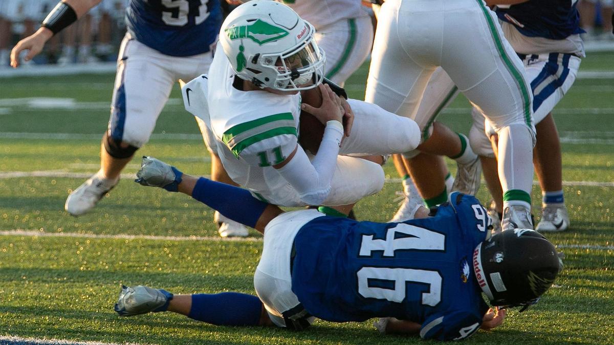 Smithvilles’s #11, Andrew Hedgecorth rolled over Grain Valley’s #46 Gabe Storment and into the end zone for the games first touchdown during Friday’s game at Grain Valley, August 27, 2021. Smithville was ahead at halftime 21-0.