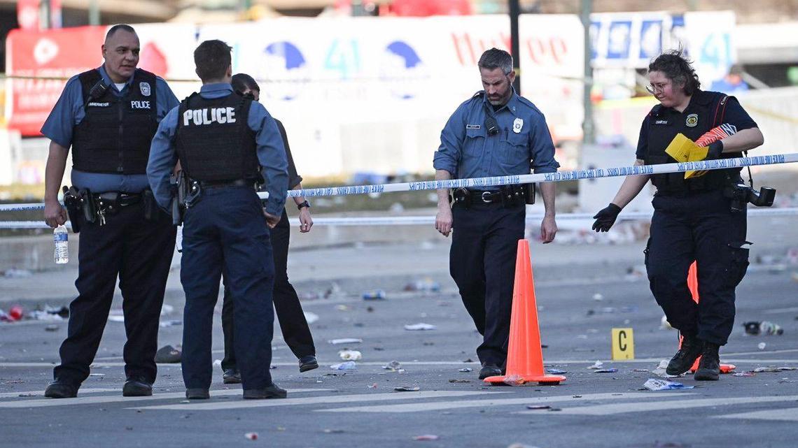 Police officers investigate the scene of a shooting where at least one person was killed and more than 20 others were injured after the Kansas City Chiefs Super Bowl LVIII victory parade Wednesday, Feb. 14, 2024, in Kansas City.