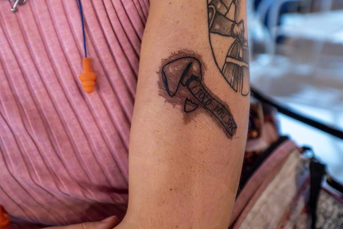 Mary Schove of Mississippi shows a new tattoo featuring a lyric from Chappell Roan's song “Good Luck, Babe” while attending a pre-party event at Incline on 9th on Thursday, Oct. 2, 2025, in Kansas City.