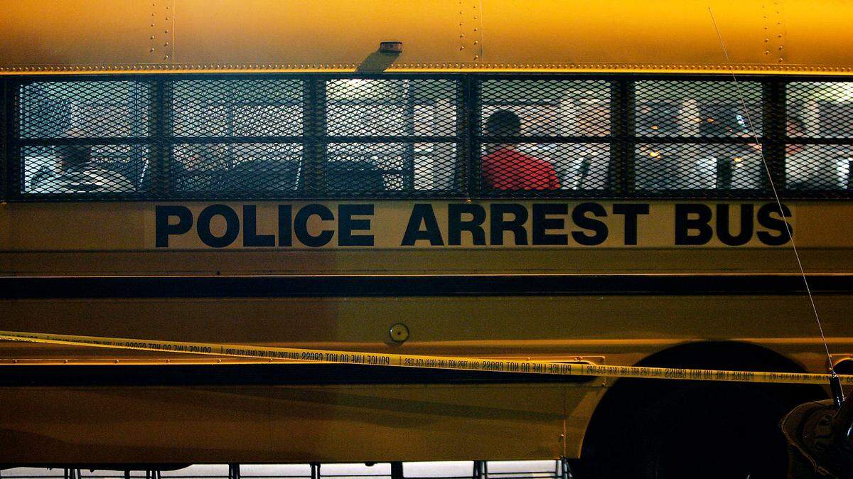 A police arrest bus holds people who were detained at a KCPD DUI checkpoint.