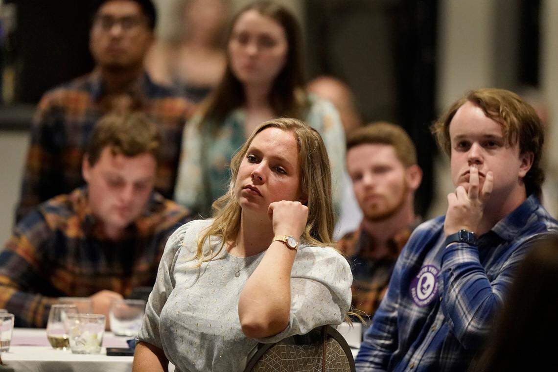People listen to a speaker at an election watch party for Value Them Both, a group in favor of a constitutional amendment removing abortion protections from the Kansas constitution, Tuesday, Aug. 2, 2022, in Overland Park, Kan.
