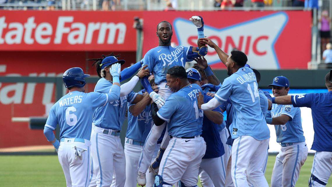 Kansas City Royals left fielder Samad Taylor (0) is lifted in the air by teammate Salvador Perez (13) after Taylor hit the game-winning single in his major league debut against the Los Angeles Angels at Kauffman Stadium on June 17, 2023.