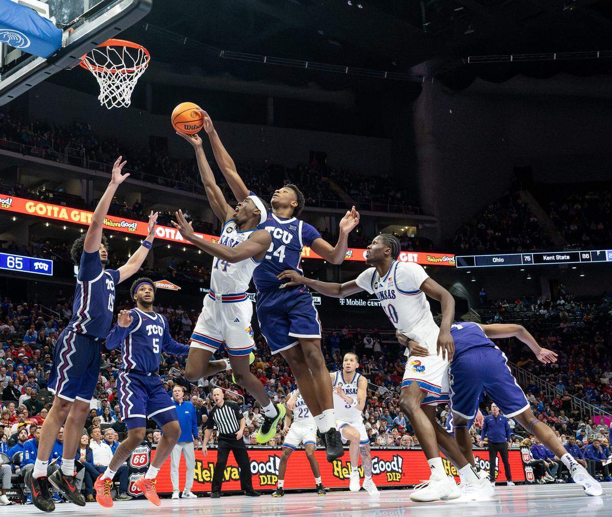 Texas Christian University Horned Frogs forward Xavier Edmonds (24) blocks a layup by Kansas Jayhawks guard Melvin Council Jr. (14) during the second half of a Big 12 Men's Basketball Tournament game at T-Mobile Center on Thursday, March 12, 2026, in Kansas City.