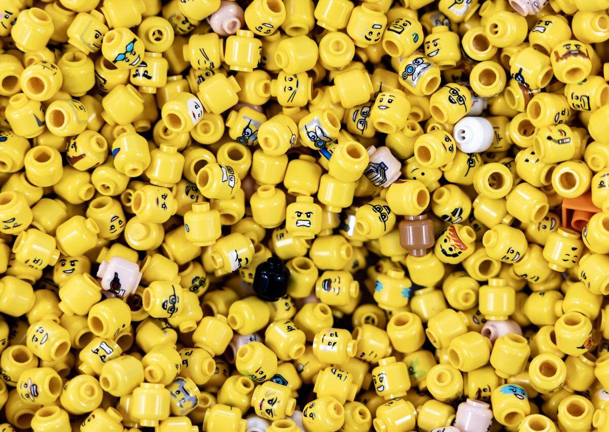 Lego mini-figure heads in a bin at Bricks & Minifigs Lee’s Summit on Thursday, Feb. 5.