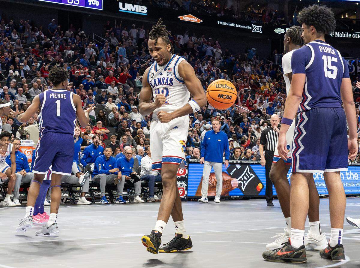 Kansas guard Darryn Peterson (22) celebrates a basket and a fouled by Texas Christian University Horned Frogs guard Jayden Pierre (1) during the second half of a Big 12 Men's Basketball Tournament game at T-Mobile Center on Thursday, March 12, 2026, in Kansas City, Mo.