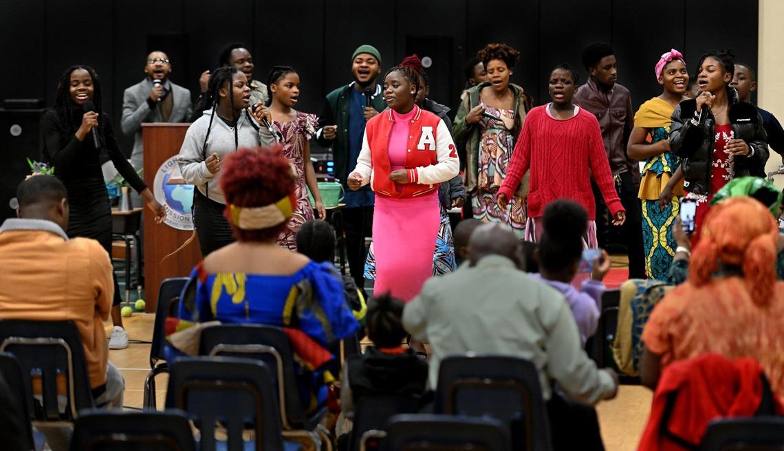 Singing religious songs in Swahili, the Salvation Choir performs weekly during Sunday services inside the gymnasium at an Independence church. 