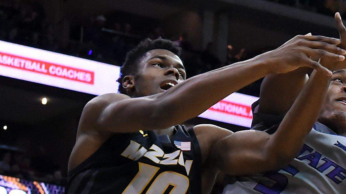 KSU's Barry Brown (middle) yanks a rebound away from MU's K.J. Walton (10) during the second half of Monday night's game at the Sprint Center. KSU won, 66-42.