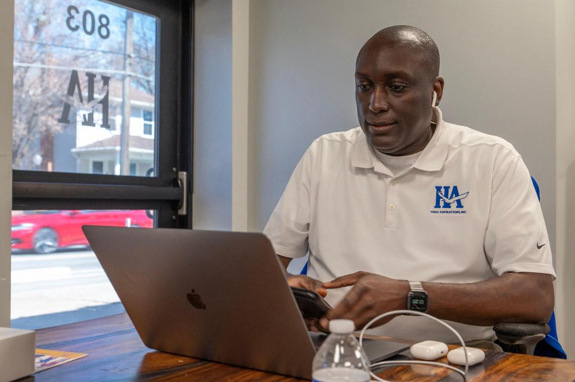 Henry Wash, founder and director of High Aspirations, attends a conference call at the organization’s Kansas City headquarters. Wash created the High Aspirations program to help shape the lives of young Black men.