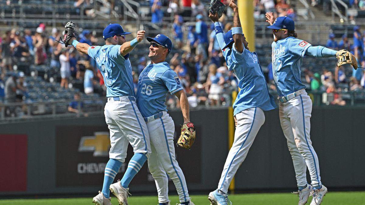 Kansas City Royals Garrett Hampson (2), Adam Frazier (26), Maikel Garcia (11) and Bobby Witt Jr. (7) celebrate after beating the Milwaukee Brewers at Kauffman Stadium.