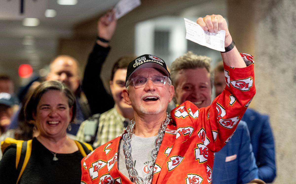 Gary Morsch celebrates as his boarding group is called to board the last commercial flight to depart from Kansas City International Airport’s old terminals on Monday, Feb. 27, 2023, in Kansas City. Morsch and his son Graham booked themselves on both the final flight out of KCI’s old terminals and the first flight scheduled to arrive to the new terminal.