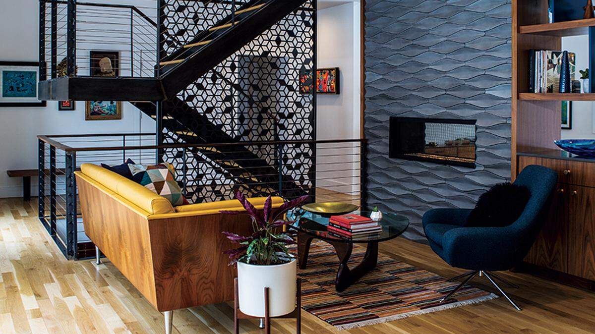 Studio Build together with Standard Sheet Metal fabricated the steel staircase and graphic panel on site. The Goetz sofa is by Herman Miller.