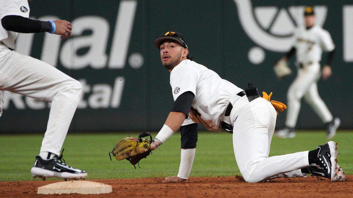 Missouri Tigers infielder Matt Garcia (4) throws to infielder Justin Colon (12) in a 6-5 win against the Texas Longhorns at Globe Life Field in Arlington, Texas, on Feb 18, 2023.