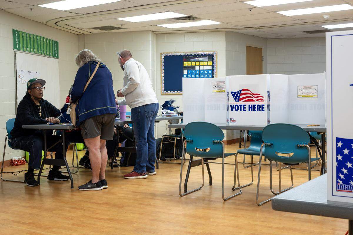 Voters sign in with volunteers at the Tony Aguirre Community Center during Election Day on Tuesday, April 7, 2026, in Kansas City.
