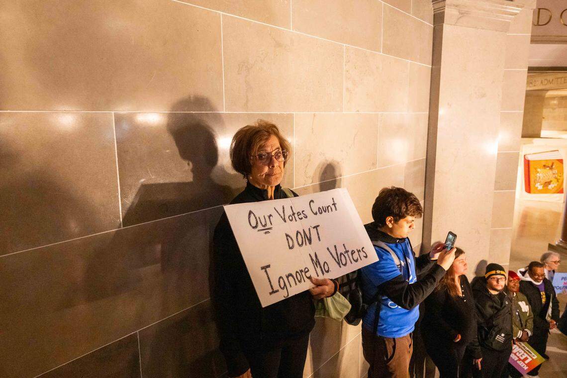 Protesters hold signs in the Missouri State Capitol rotunda on Wednesday, January 21, 2026 in Jefferson City. Organizations and allies gathered to protest recent Missouri lawmaker's decisions.