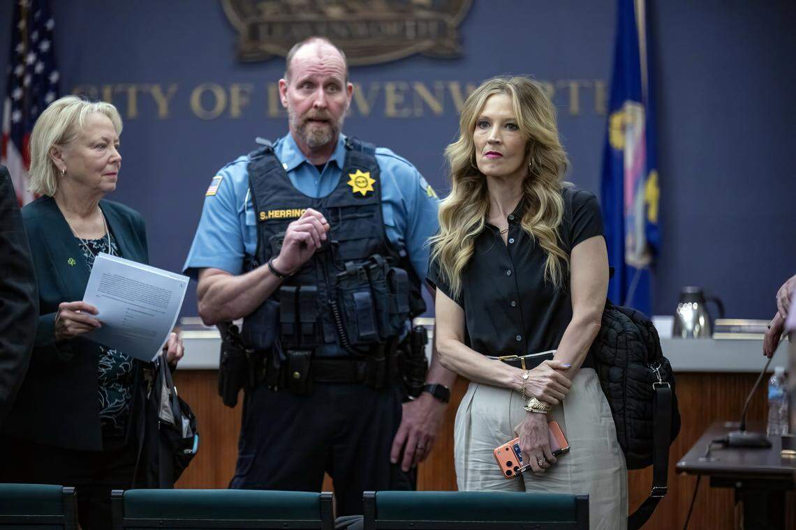 Leavenworth police staged upfront after the Leavenworth city commission, including Mayor Nancy Bauder, left, and city commissioner Holly Pittman, approved a zoning permit Tuesday, March 10, 2026, that allows a private prison company, CoreCivic, to reopen its shuttered prison on the outskirts of town as an ICE detention center. 