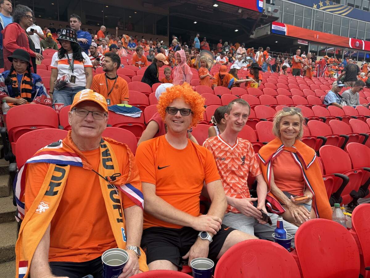 Wouter Tel (middle) and his friends watching the Netherlands take on Tunisia in the FIFA World Cup June 25 at Kansas City Stadium in Kansas City, Missouri.