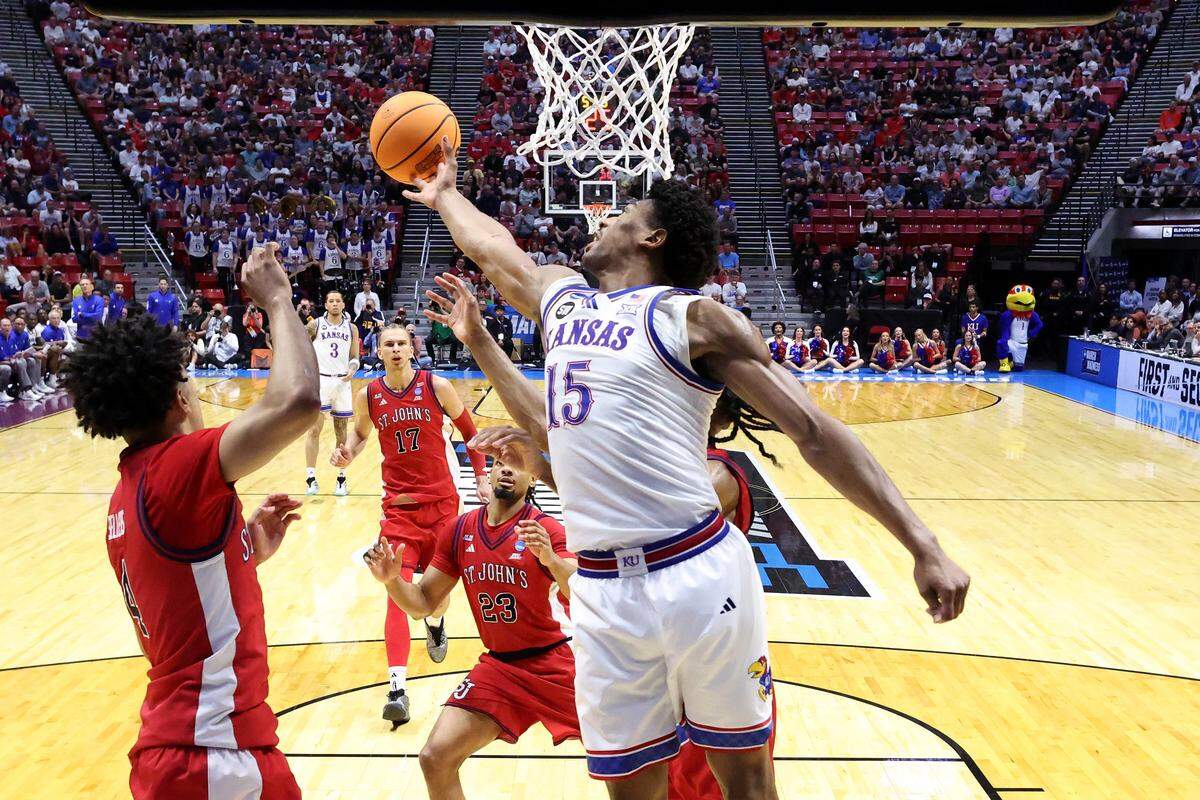 Bryson Tiller #15 of the Kansas Jayhawks reaches for the ball against Oziyah Sellers #4 of the St. John's Red Storm during the first half at Viejas Arena on March 22, 2026 in San Diego.