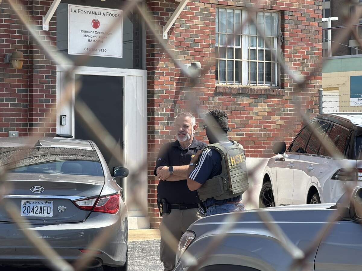 Federal agents speak outside of La Fontanella Foods on Thursday, July 9, after several people appears to be arrested at the facility in Kansas City.