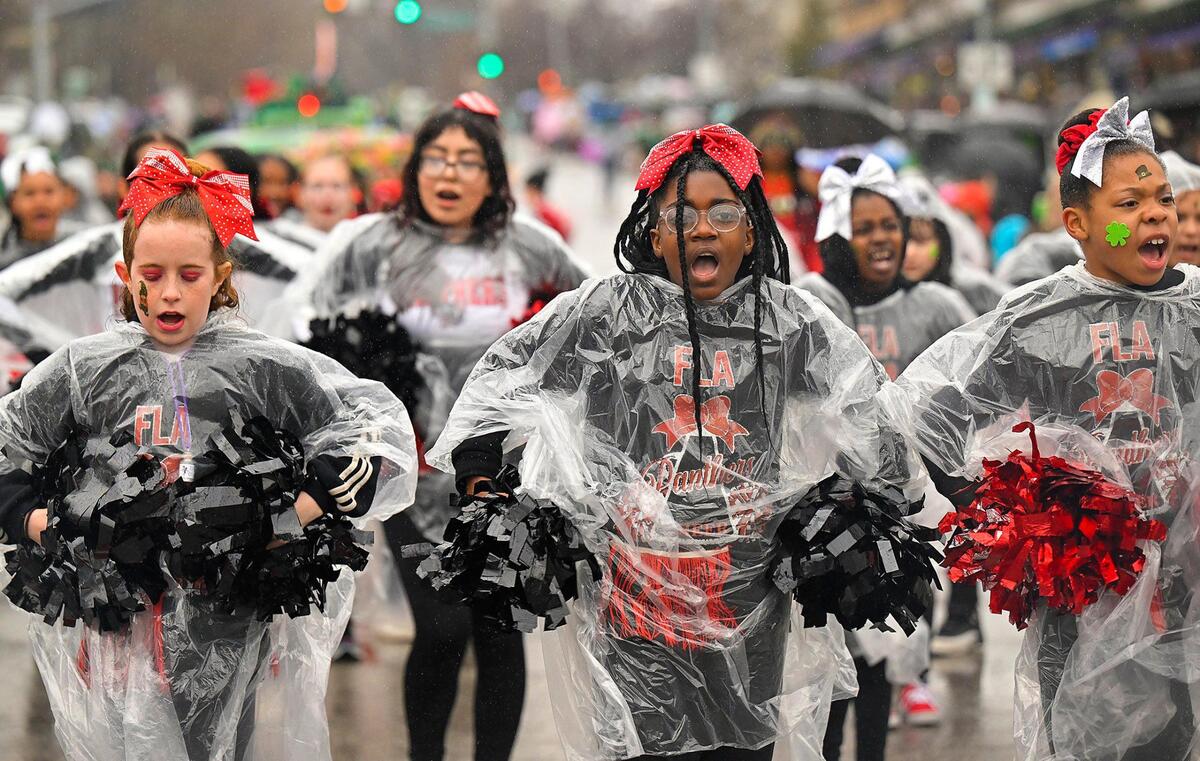 Extreme Team members from the Foreign Language Academy danced in the rain during the 2023 Brookside St. Patrick’s Day Warm-Up Parade on Saturday March 11, 2023 in Kansas City.