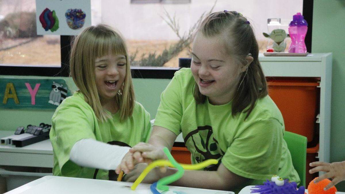 Best friends shared a laugh during a 2016 open house at Emma’s Place in Overland Park. Emma’s Place is a day care dedicated to students with special needs.