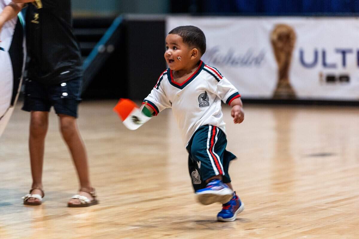 Eliam Guerreo runs around waving a Mexican Flag at the KCK Mexico v. South Africa Watch Party hosts at Memorial Hall on Thursday, June 11, 2026.