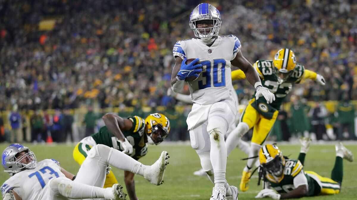 Detroit Lions running back Jamaal Williams (30) rushes for a third quarter touchdown against Green Bay Packers during their football game on Jan. 8, 2022 at Lambeau Field in Green Bay, Wisconsin.