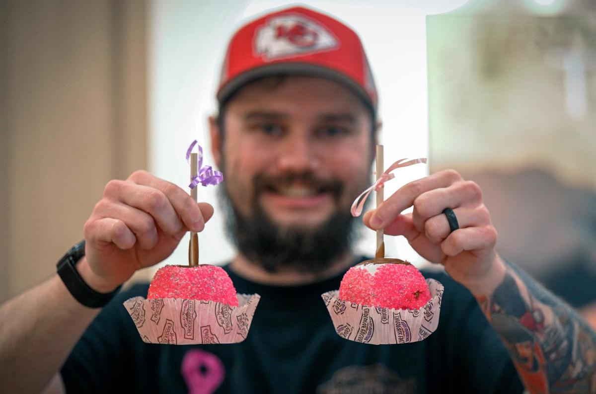 Matt Geehan, owner of Rocky Mountain Chocolate Factory at Union Station, display two of the pink Sprinkles Apples, he is selling to Barbie fans visiting Union Station.. Geehan said pink sprinkles have become quite costly for him to purchase since the Barbie movie craze began.
