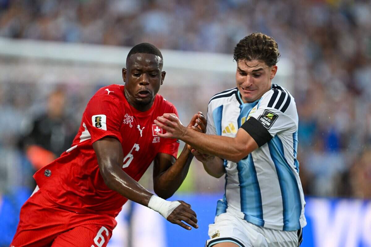 Switzerland midfielder Denis Zakaria (6) and Argentina forward Julián Álvarez (9) get physical in the Argentina vs. Switzerland 2026 World Cup Quarterfinal football match at Kansas City (Arrowhead) Stadium in Kansas City on Saturday, July 11, 2026.