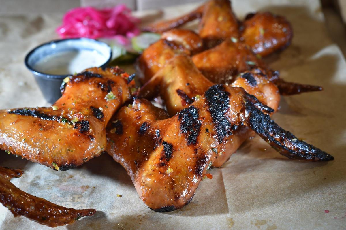 Executive Chef and Pit Master Ted Liberda is opening Buck Tui, a Thai Kansas City barbecue restaurant in the space once occupied by Plowboys Barbeque, 6737 W. 75th St. in Overland Park. On the menu, Liberda features Tiger Cry Wings with a spicy Tiger Cry Sauce.