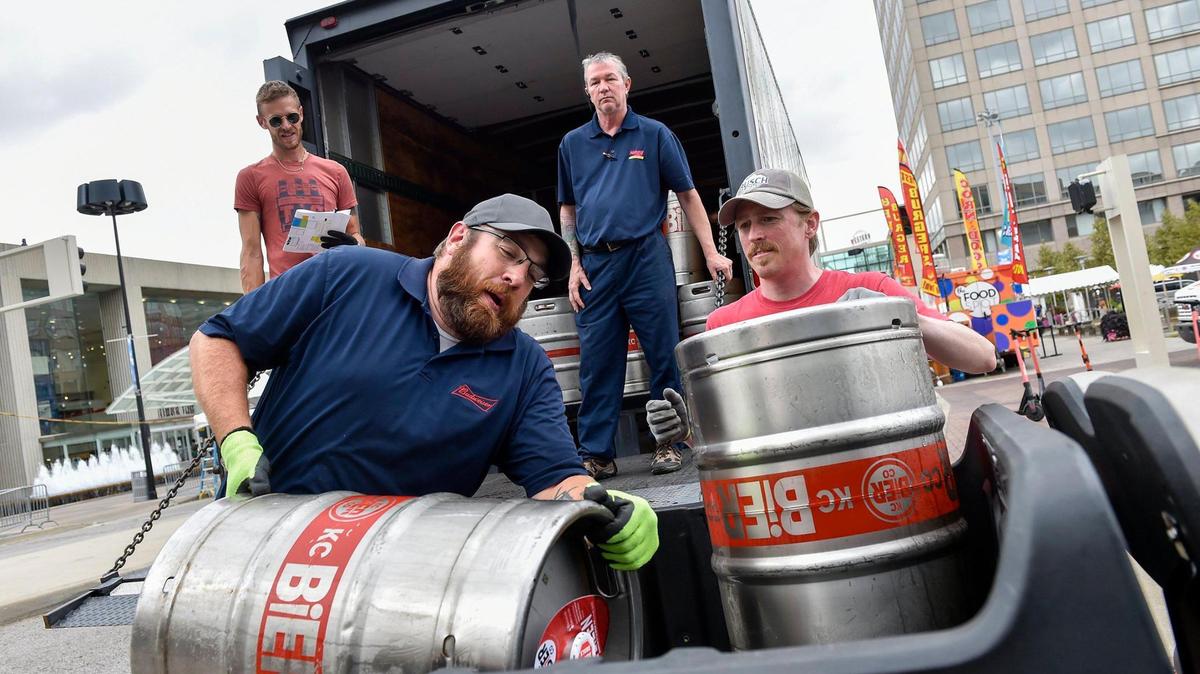 Pat Finn loads one of many kegs of beer onto a utility cart to prepare for KC Oktoberfest 2021.