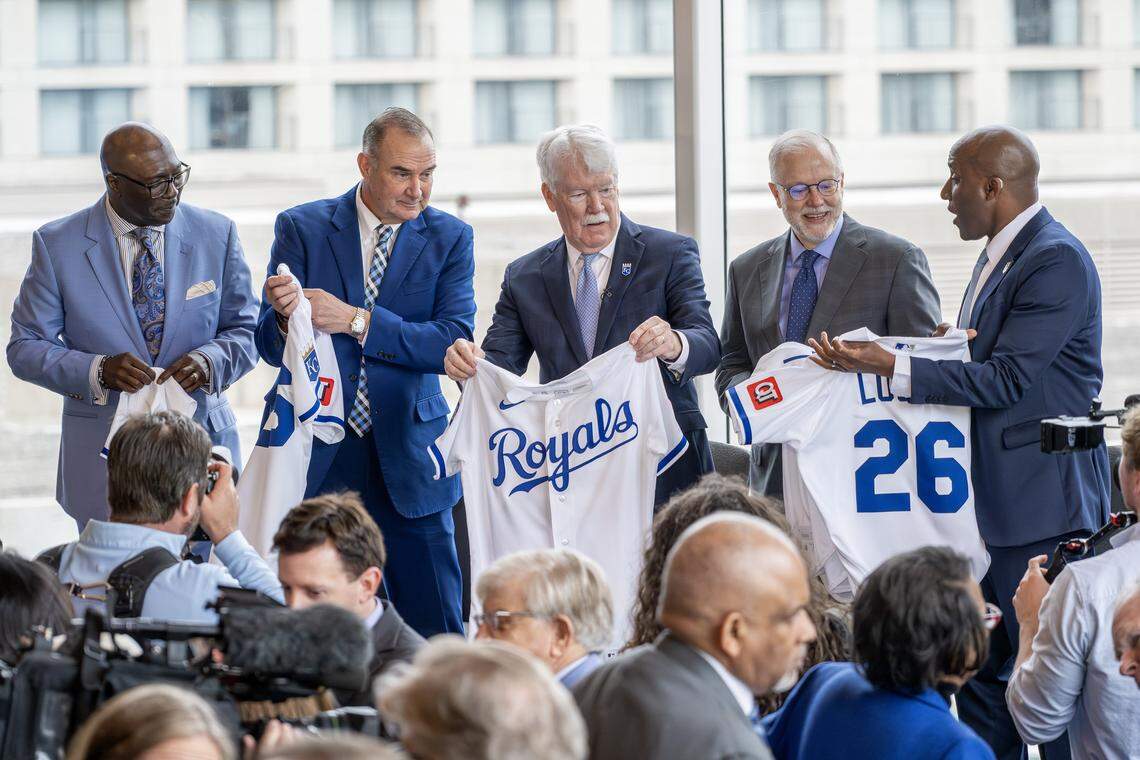 Bob Kendrick, president of the Negro Leagues Baseball Museum, left, Missouri Gov. Mike Kehoe, John Sherman, chairman and CEO of the Kansas City Royals, Donald J. Hall Jr., executive chairman and former CEO of Hallmark Cards, and Kansas City Mayor Quinton Lucas hold Royals jerseys during a ceremony announcing the team’s move to Crown Center on Wednesday, April 22, 2026, in Kansas City.