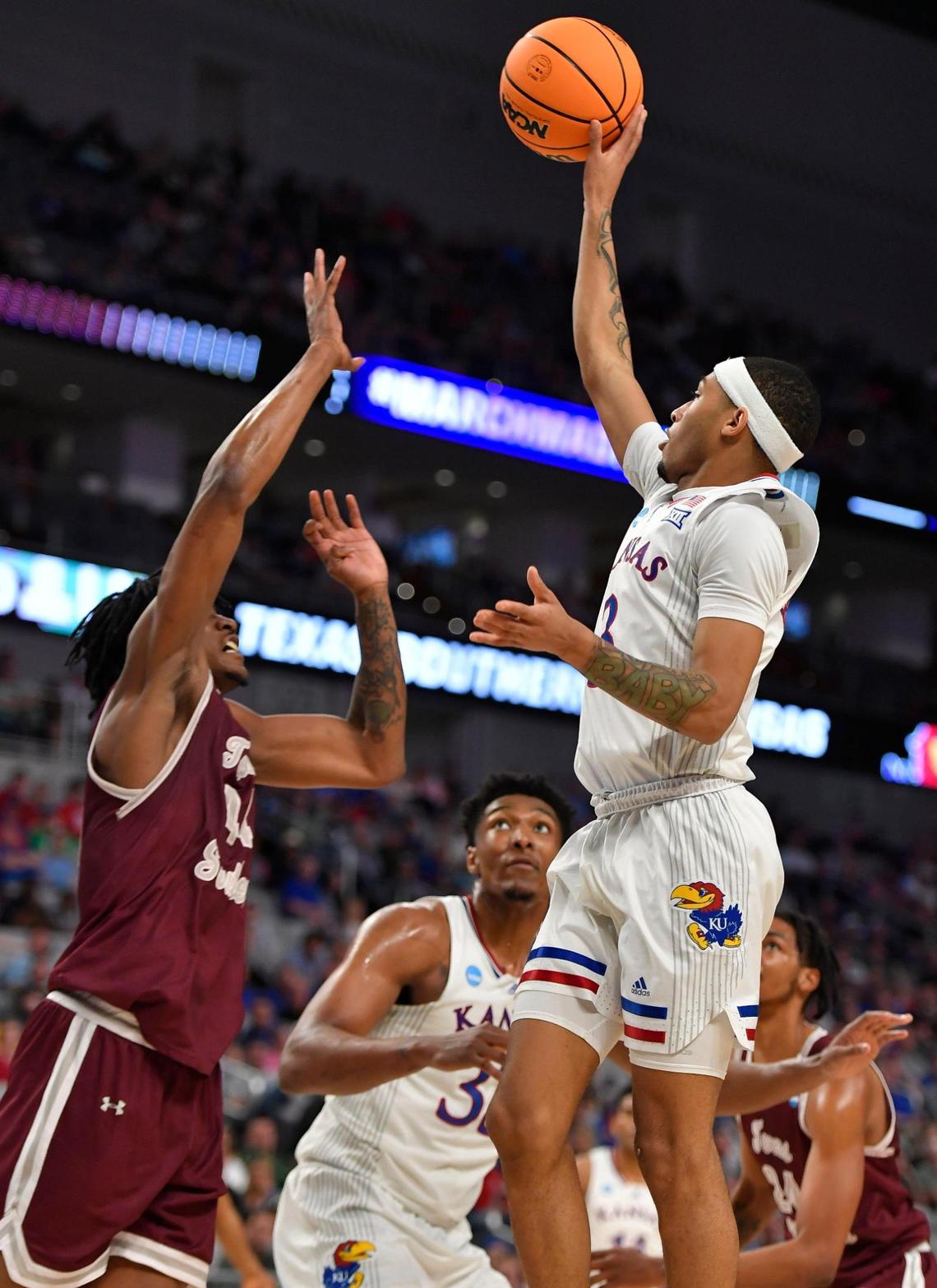 KU’s Dajuan Harris hit this runner of the glass over Texas Southern’s Brison Gresham during the first half of a first round NCAA Tournament game in Fort Worth. KU beat Texas Southern 83-56.