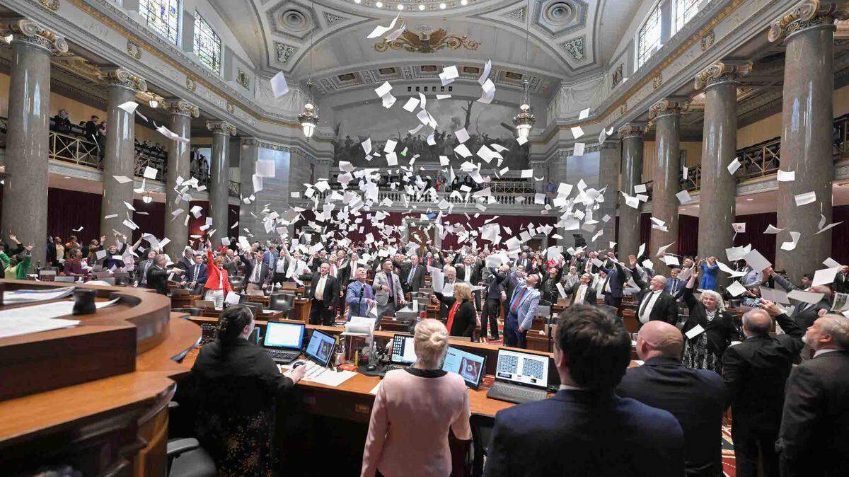 Lawmakers in the Missouri House toss papers in the air at the end of the legislative session. The General Assembly didn’t pass an extension of the economic ceasefire agreement with Kansas.