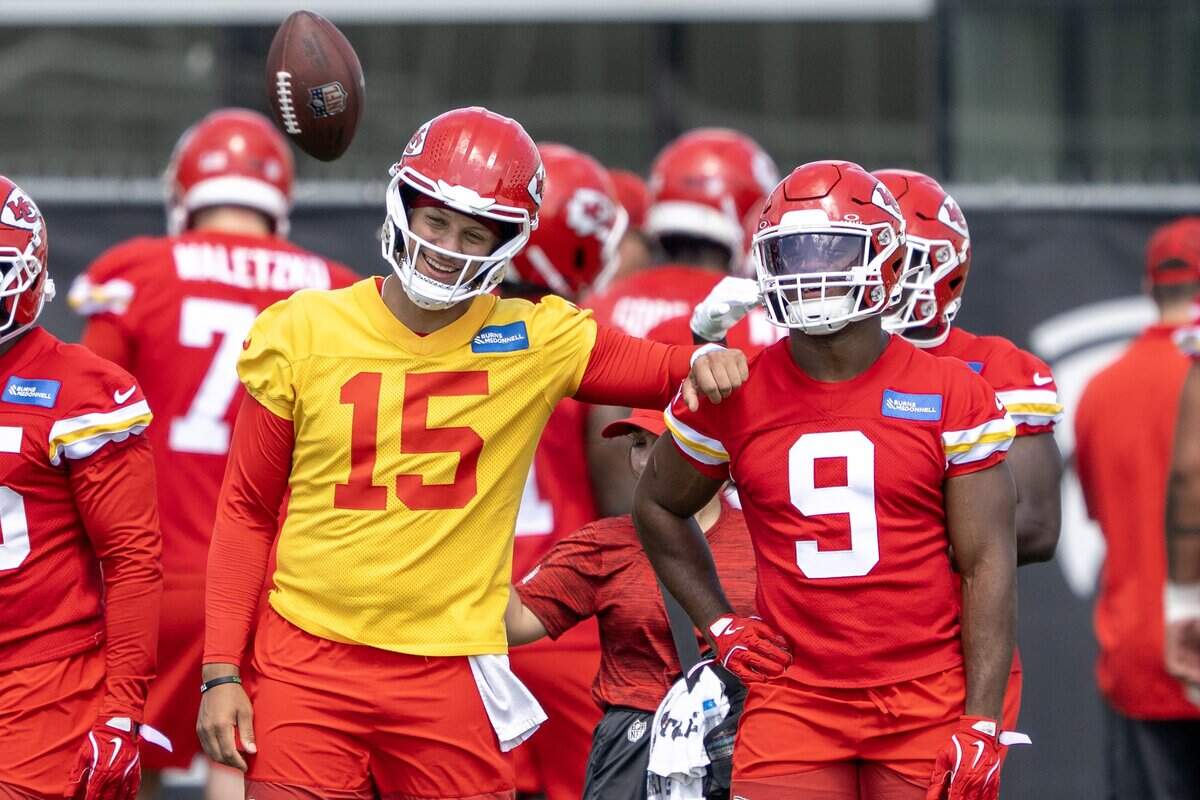 Kansas City Chiefs quarterback Patrick Mahomes (15) and running back Kenneth Walker smile while running drills during minicamp practice at the Chiefs' practice facility on Wednesday, June 10, 2026, in Kansas City.