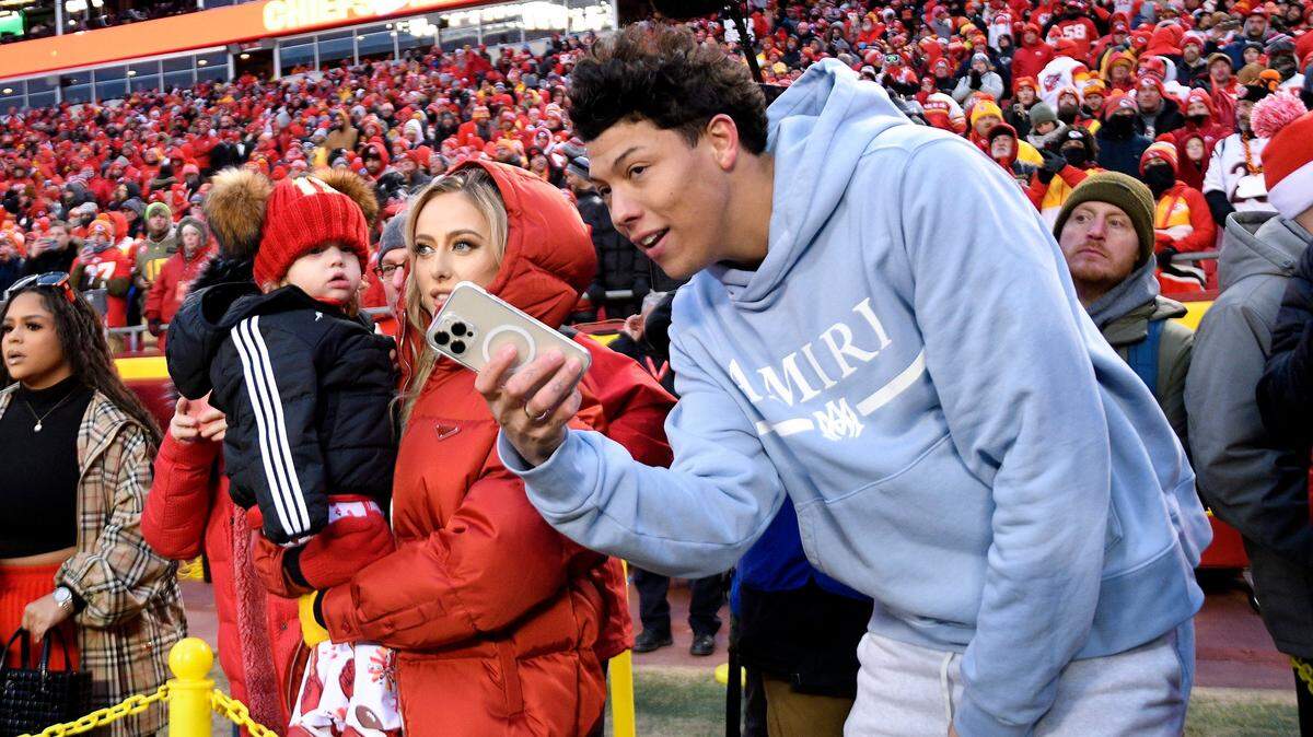 Brittany Mahomes, wife of Chiefs quarterback Patrick Mahomes, holds their daughter, Sterling, as her brother-in-law Jackson Mahomes talks with her before the Chiefs AFC Championship game against Cincinnati on Sunday, Jan. 29, 2023, at Arrowhead Stadium in Kansas City.