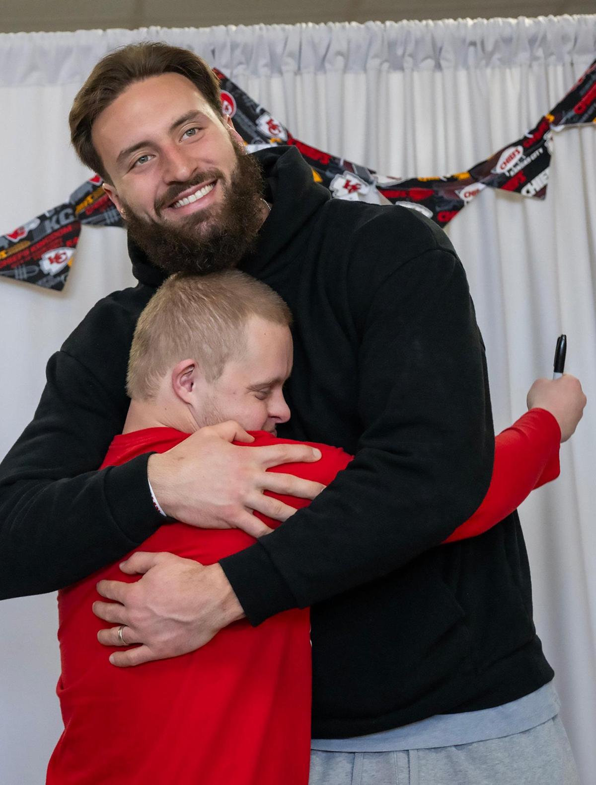 Kansas City Chiefs tight end Noah Gray gets a heartfelt hug from Sam Rogers, 28, during a visit to PawsAbilities.